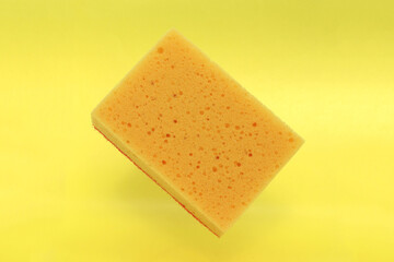 Yellow sponge in the air, yellow colorful background