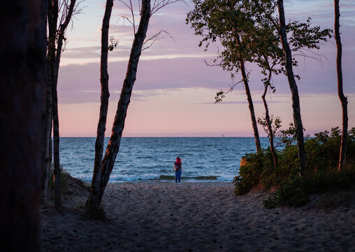 silhouette of a person walking on the beach