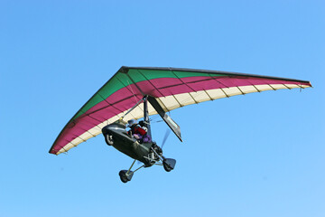 Ultralight airplane flying in a blue sky