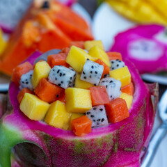 Fresh tropical fruit salad in dragon fruit skin - healthy breakfast, weight loss concept. Thailand,