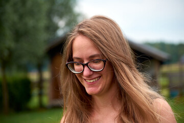 A closeup of a beautiful smiling woman with blond long hair