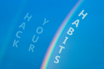 Hack your habits symbol. Rainbow in the blue sky. Words Hack your habits. Peaceful nature. Beautiful blue background. Business, psychology and hack your habits concept, copy space.