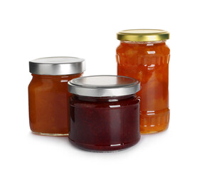 Jars with different jams on white background