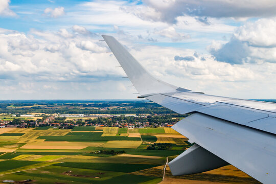 Plain wing over Belgium. Flight from Amsterdam to Brussels.