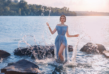 Greek mythical fairytale fantasy woman goddess nymph emerges from lake. Splashes of water. Vintage...