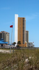 Obraz premium Red flag flying on Panama City Beach, Florida, USA, shortly after the beaches reopened following COVID-19 public health closures
