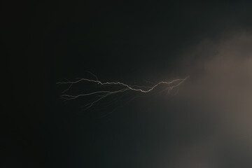 lightning in the night sky. heavy thunderstorms with striking
