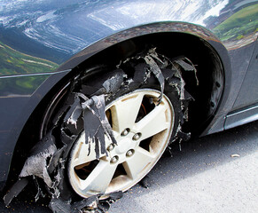 Severely blown-out tire ripped to shreds.