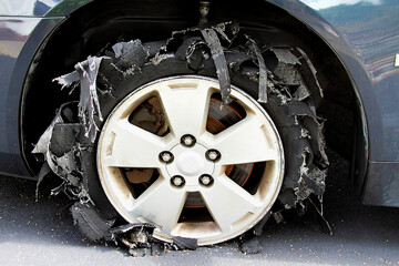 Severely blown-out tire ripped to shreds.