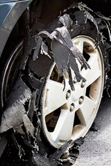 Severely blown-out tire ripped to shreds.
