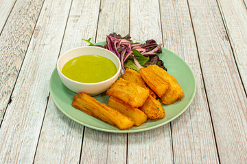 Great fried yucca chunks with guacamole sauce to dip with red onion and lettuce