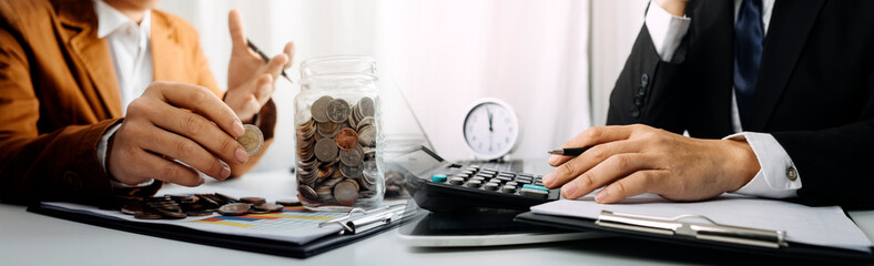 Business people using tablets And using his finger to touch the screen With a business graph showing up in a virtual screen.New startup ideas and business growth concept.