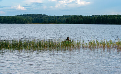 Fototapeta na wymiar Fisherman on lake