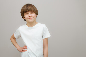 Confident boy in white t-shirt smile at camera.