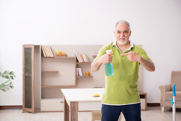 Old man cleaning the house