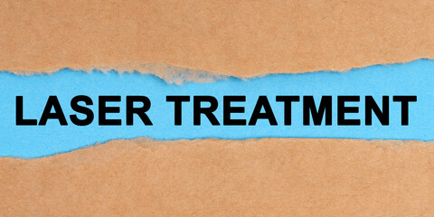 The paper is ripped in the middle. Inside on a blue background it is written - Laser Treatment