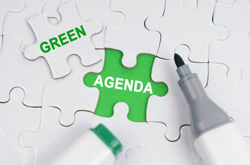 White puzzles lie on a green background, in place of an open puzzle it is written - Green agenda