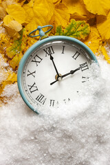 Clock switch to winter time. Close up, top view, background