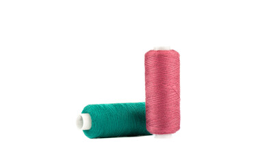 Spools of red and green thread isolated on white background.