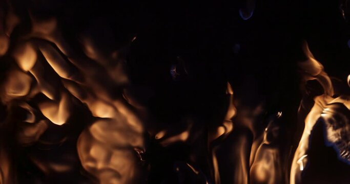 A slow-motion shot of fire flames on a black background.