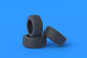 Heap of car tyres on blue background. Automotive parts. Traffic safety. Automobile service. Buying, selling of tires. 3d render