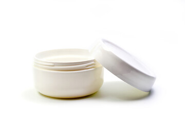 Empty White Plastic opaque cream jar with lid. Isolated on white background. Cosmetic product for skin care
