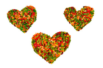 Heart made of vegetables. Corn, carrot, bell pepper, green beans. Isolated on white.