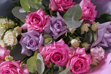 A large bouquet of flowers in close-up. Large pink roses. On a light background, top view. Horizontal composition. High quality photo