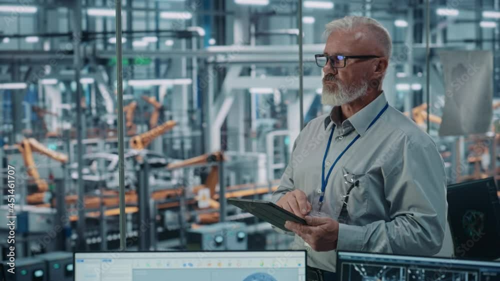 Poster car factory office: portrait of senior white male chief engineer using tablet computer in automated 