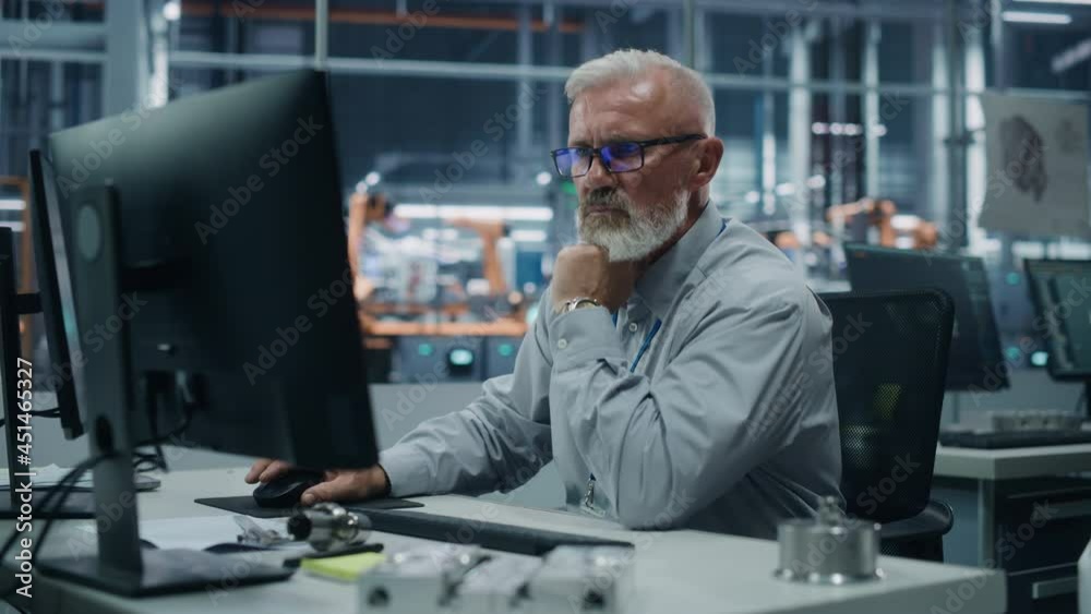 Poster car factory office: portrait of senior male chief engineer working on desktop computer in automated 