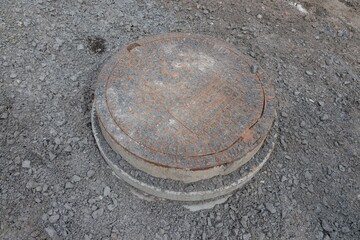 Manhole cover bared up the over ground in construction building asphalt rod reconstruction site