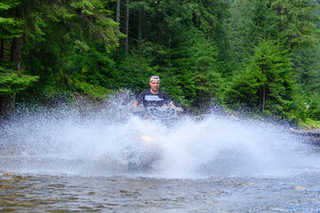 ATV racing on on mountain river  track at summer mountain