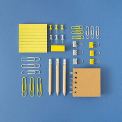 September ,back to school, office concept. Various school  office supplies. Square arrangement pencils , tapes, erasers, pins, rulers, markers, paper clips, posit notes, notes .Bright blue background.