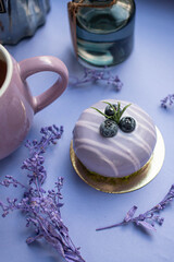 lavender cake on blue table with flowers