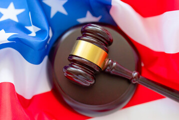 brown gavel against the background of the American flag, the concept of a fair judicial system in...