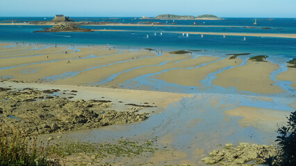 Panoramic view over bay during low tide in atlantic ocean with small islands and blue slightly...