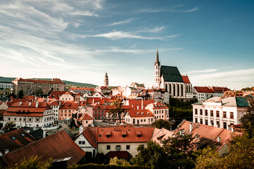 Naklejka na ściany i meble Beautiful view of the church and castle. Cesky Krumlov with St Vitus church in the middle of historical city centre. Cesky Krumlov, Southern Bohemia, Czech Republic