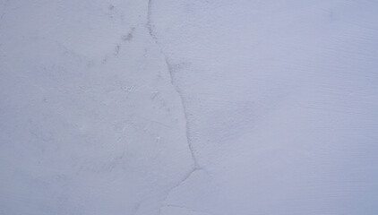 Old wall with cracked blue plaster.