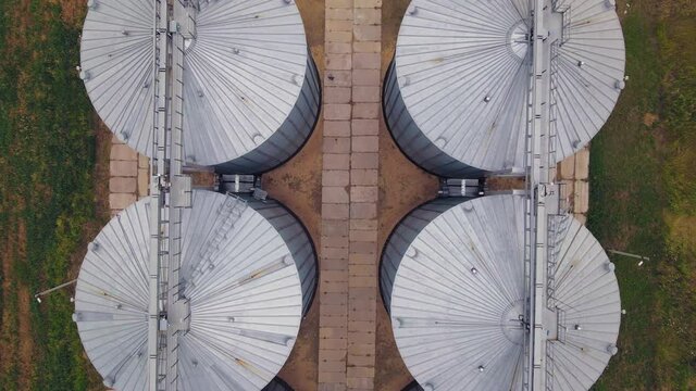 Aerial view of metal grain elevator in agricultural zone. Grain storage warehouse