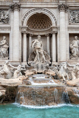 The Trevi Fountain in Rome on a cloudy summer day.