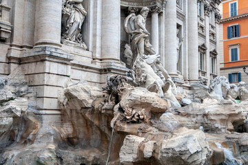 The Trevi Fountain in Rome on a cloudy summer day.