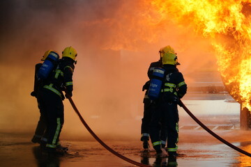 industrial fire, fire fighters fighting large industrial fire 