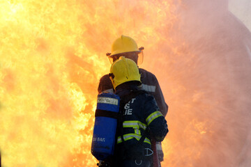 industrial fire, fire fighters fighting large industrial fire 