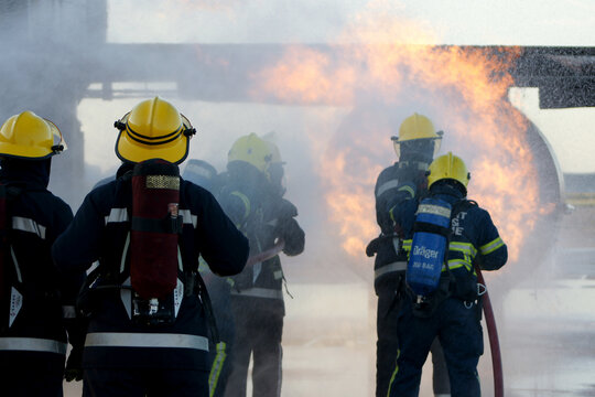 industrial fire, fire fighters fighting large industrial fire 