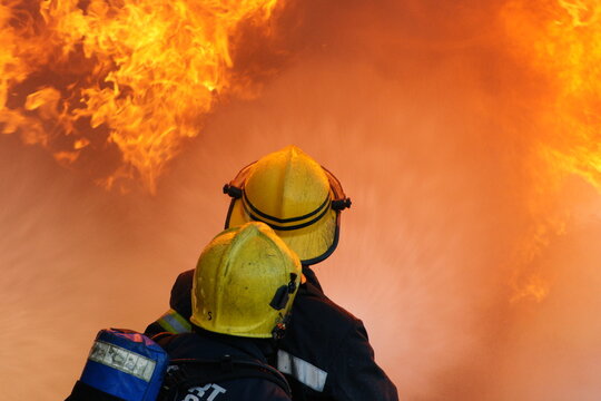 industrial fire, fire fighters fighting large industrial fire 