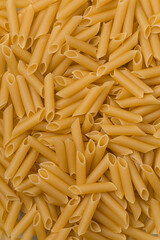 Solid background of raw pasta