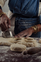 baker cutting biscuits from rolled dough
