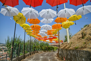 Colorful umbrellas in the cityscape of Acri, a medieval village in the Calabria region of Italy.