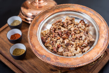 Spicy minced lamb kokorec in a copper skillet.