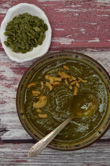 Fototapeta na wymiar Vegan beet greens and potato creamed soup in a rustic setting